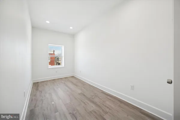 a view of an empty room and wooden floor