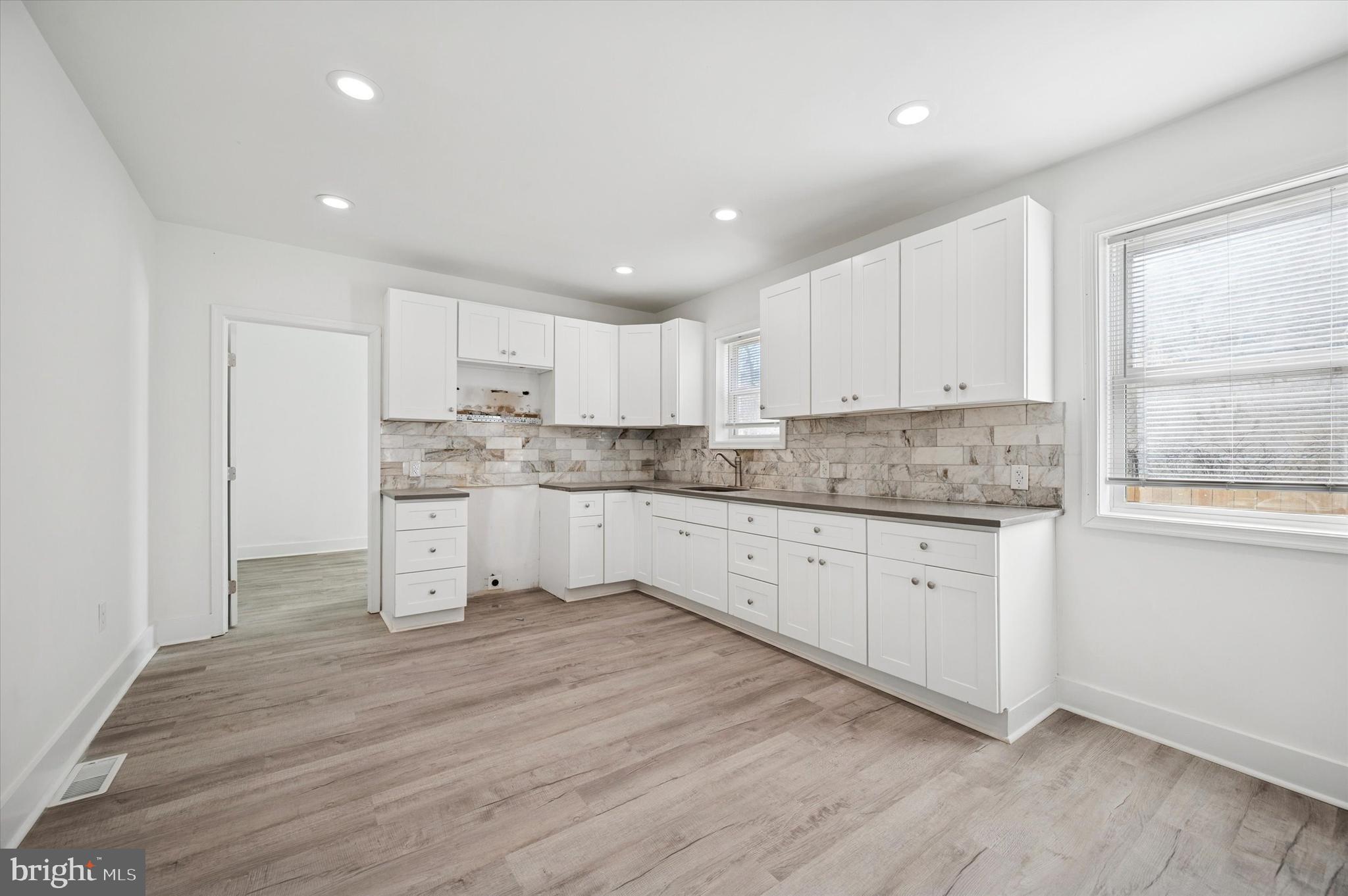 2135 North 20th Street Philadelphia, PA 19121 - Photo 3 of 20 a kitchen with granite countertop white cabinets and white appliances