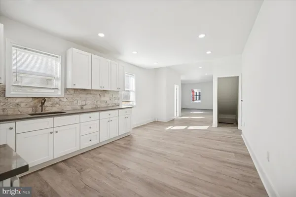 a view of a kitchen with granite countertop cabinets and wooden floor