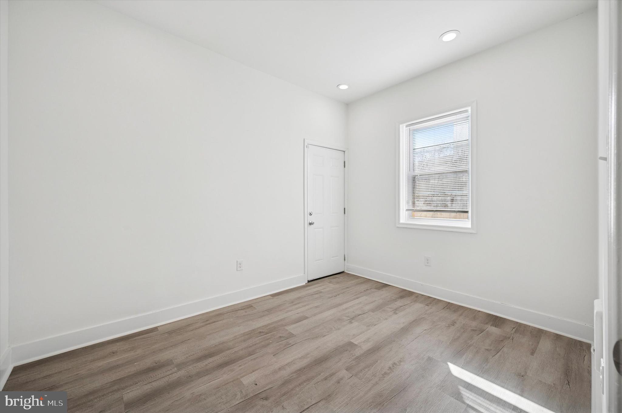 2135 North 20th Street Philadelphia, PA 19121 - Photo 10 of 20 an empty room with wooden floor and windows