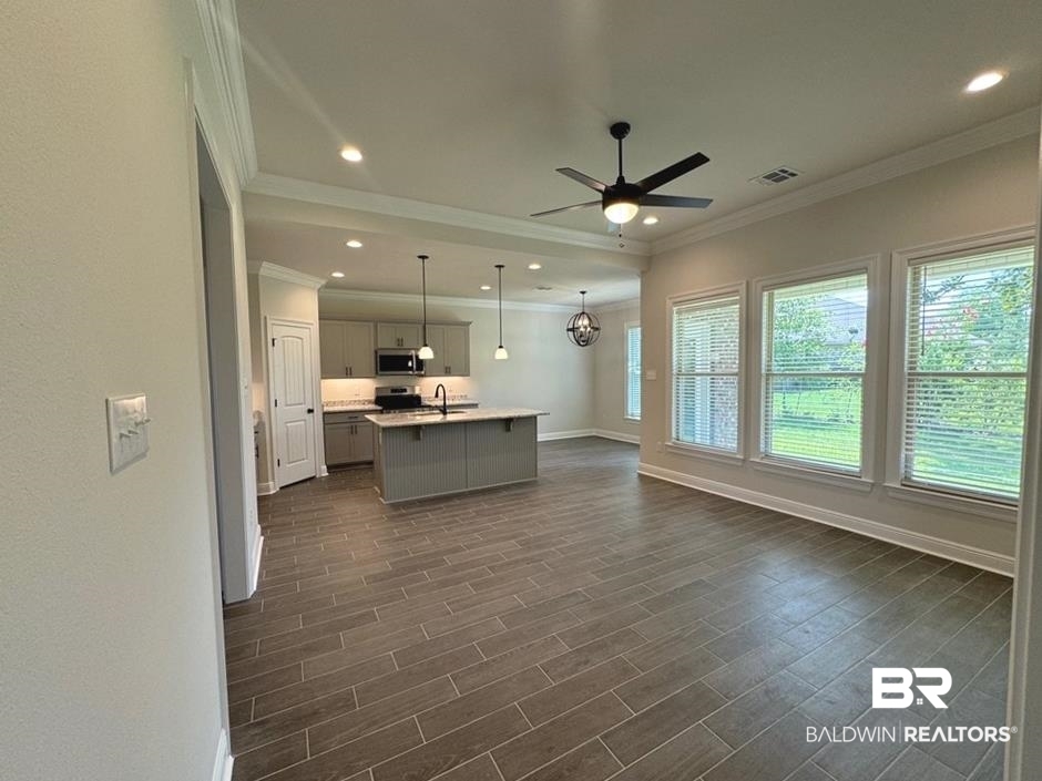 844 Sumter Loop Foley, AL 36535 - Photo 6 of 18 Interior space featuring ceiling fan, pendant lighting, an island with sink, sink, and gray cabinetry