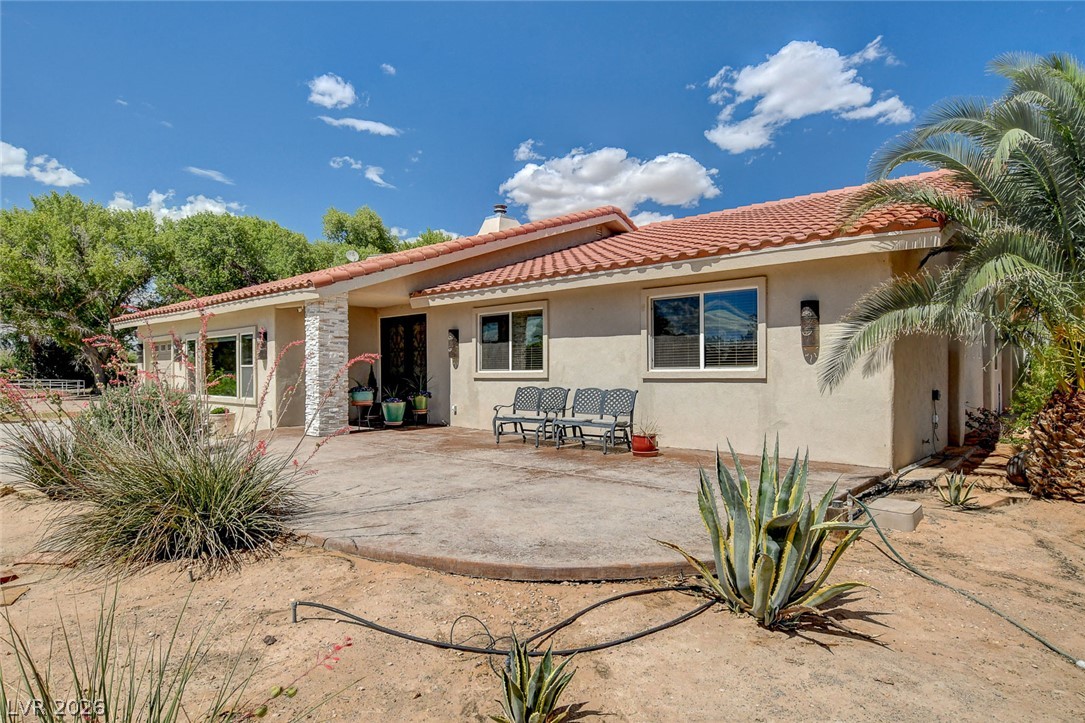 1950 Bowman Road Logandale, NV 89021 - Photo 3 of 81 A terracotta tile roof tops this stucco home, offering a large concrete patio perfect for outdoor living.