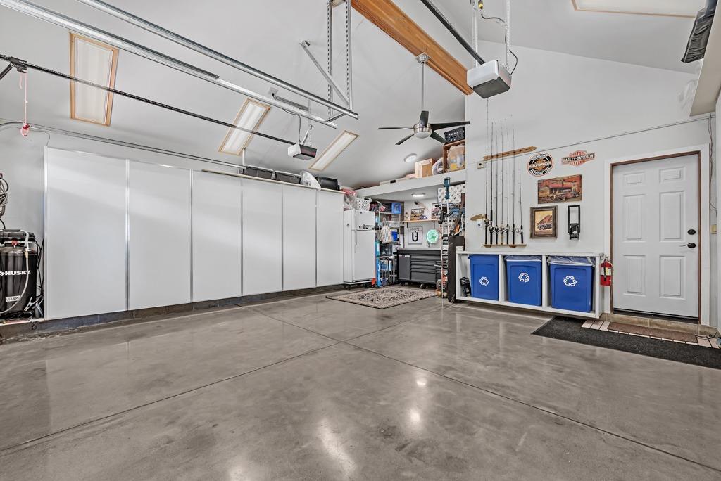 4607 Meadowlark Way Placerville, CA 95667 - Photo 47 of 58 Interior of 2 car attached garage with vaulted ceiling, ceiling fan, garage door opener, recycling area, work shop area.