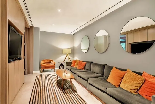 a living room with furniture and a table with wooden floor