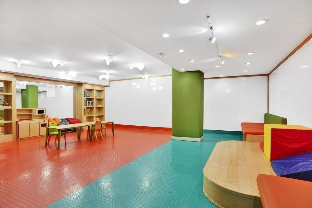 225 Rector Place, Unit 9B Manhattan, NY 10280 - Photo 14 of 14 a living room with furniture and a table with wooden floor