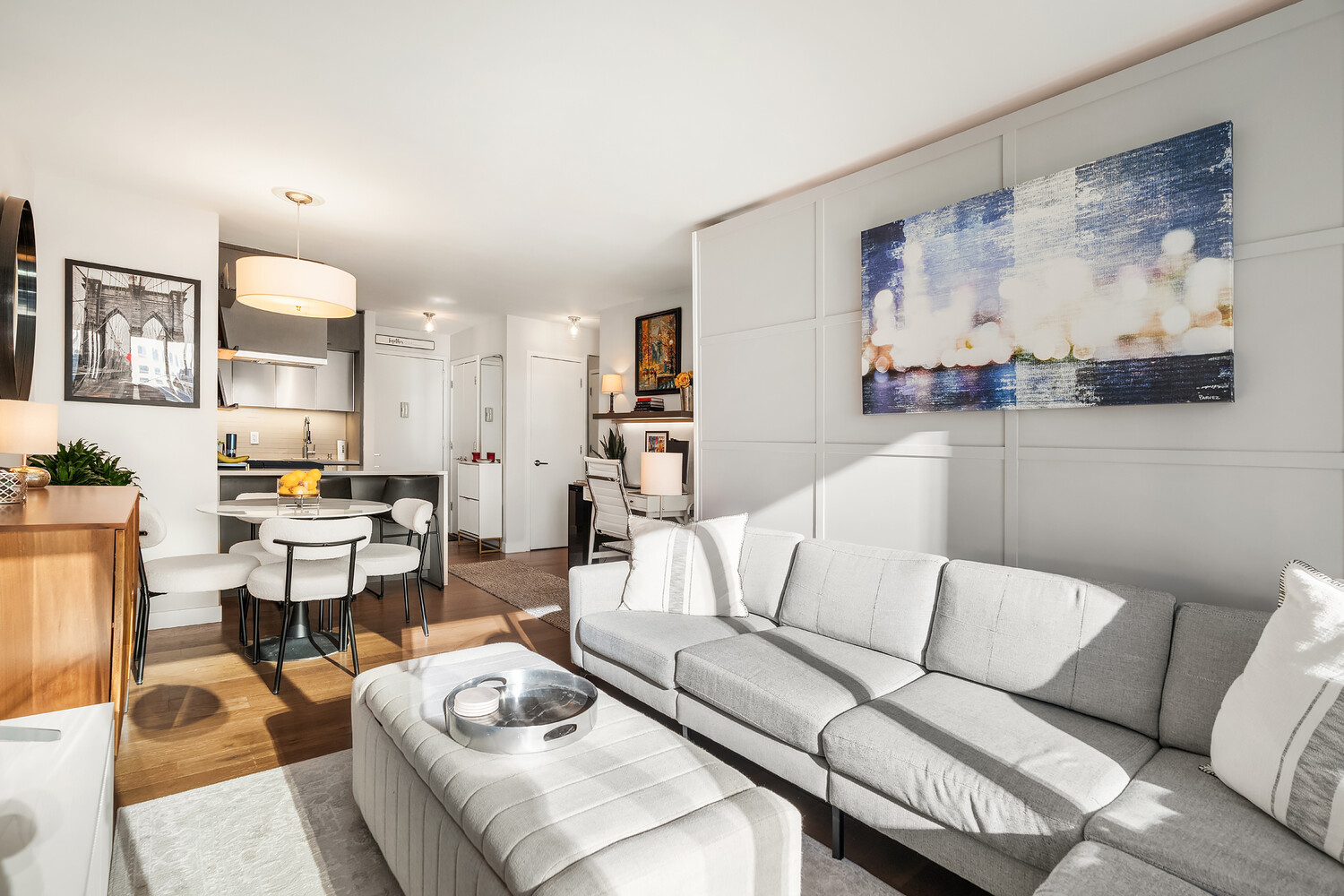 225 Rector Place, Unit 9B Manhattan, NY 10280 - Photo 2 of 14 a living room with furniture and view of kitchen