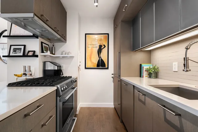 a kitchen with stainless steel appliances granite countertop a sink stove and cabinets