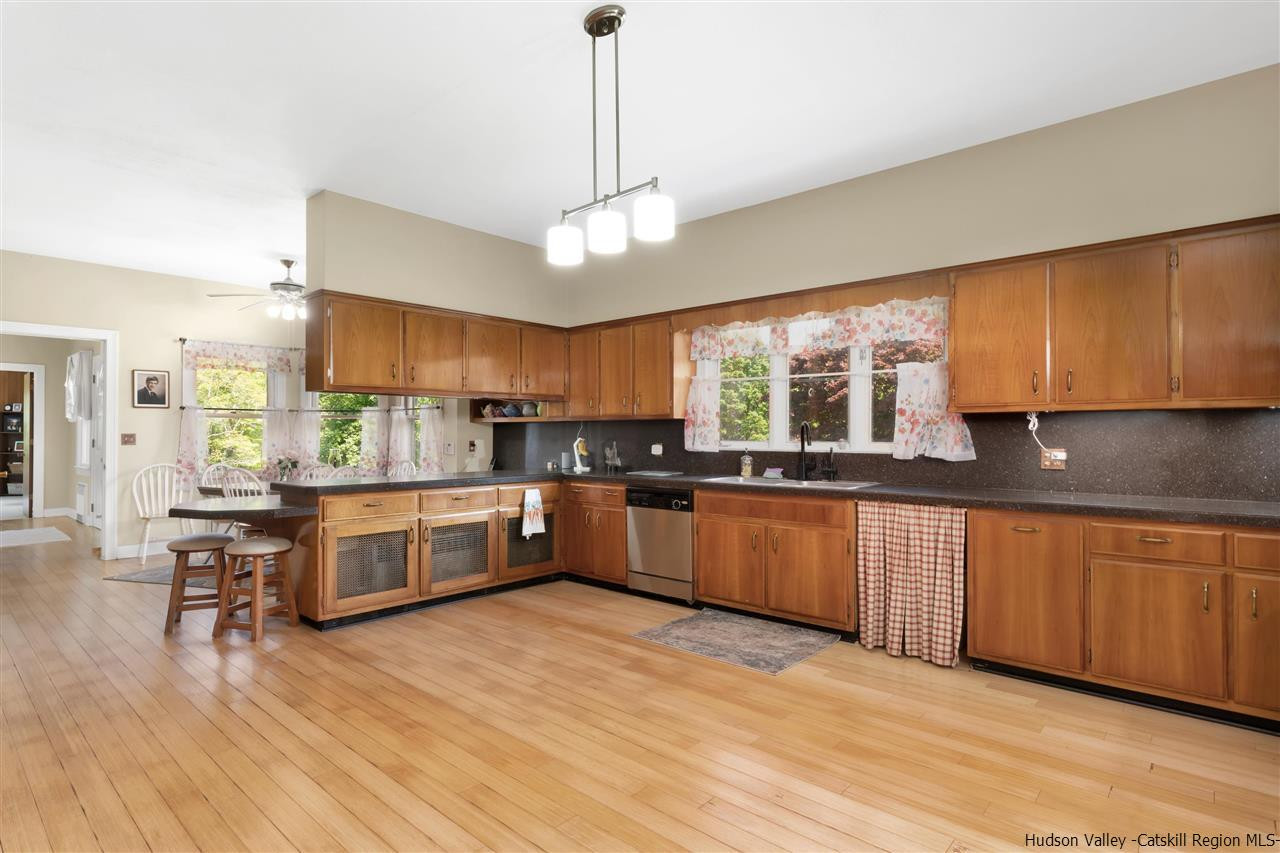 295 Game Farm Road Catskill, NY 12414 - Photo 11 of 35 a large kitchen with stainless steel appliances kitchen island granite countertop a large counter top space and a center island