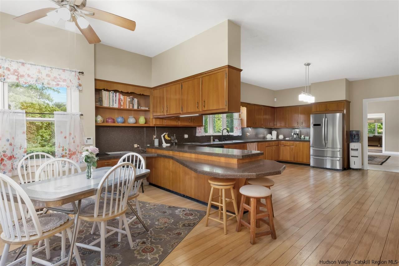 295 Game Farm Road Catskill, NY 12414 - Photo 14 of 35 a kitchen with granite countertop kitchen island stainless steel appliances a dining table and chairs