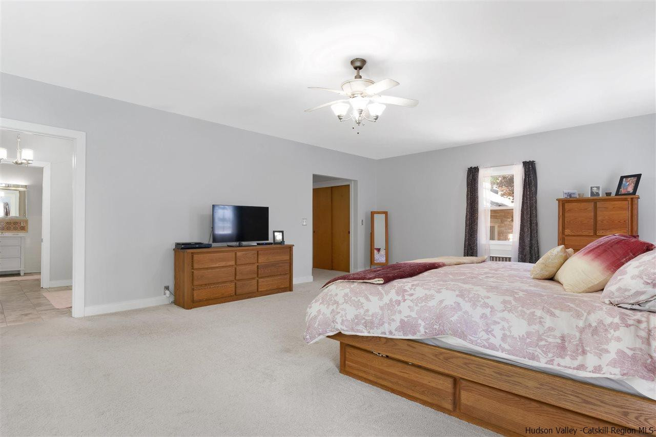 295 Game Farm Road Catskill, NY 12414 - Photo 17 of 35 a bedroom with a large bed and a flat screen tv