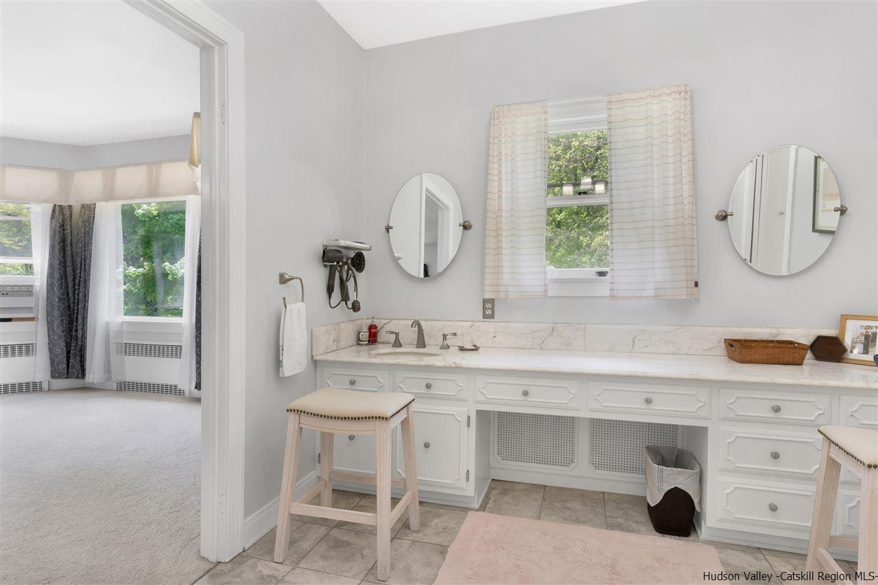 295 Game Farm Road Catskill, NY 12414 - Photo 19 of 35 a bathroom with a double vanity sink mirror and window