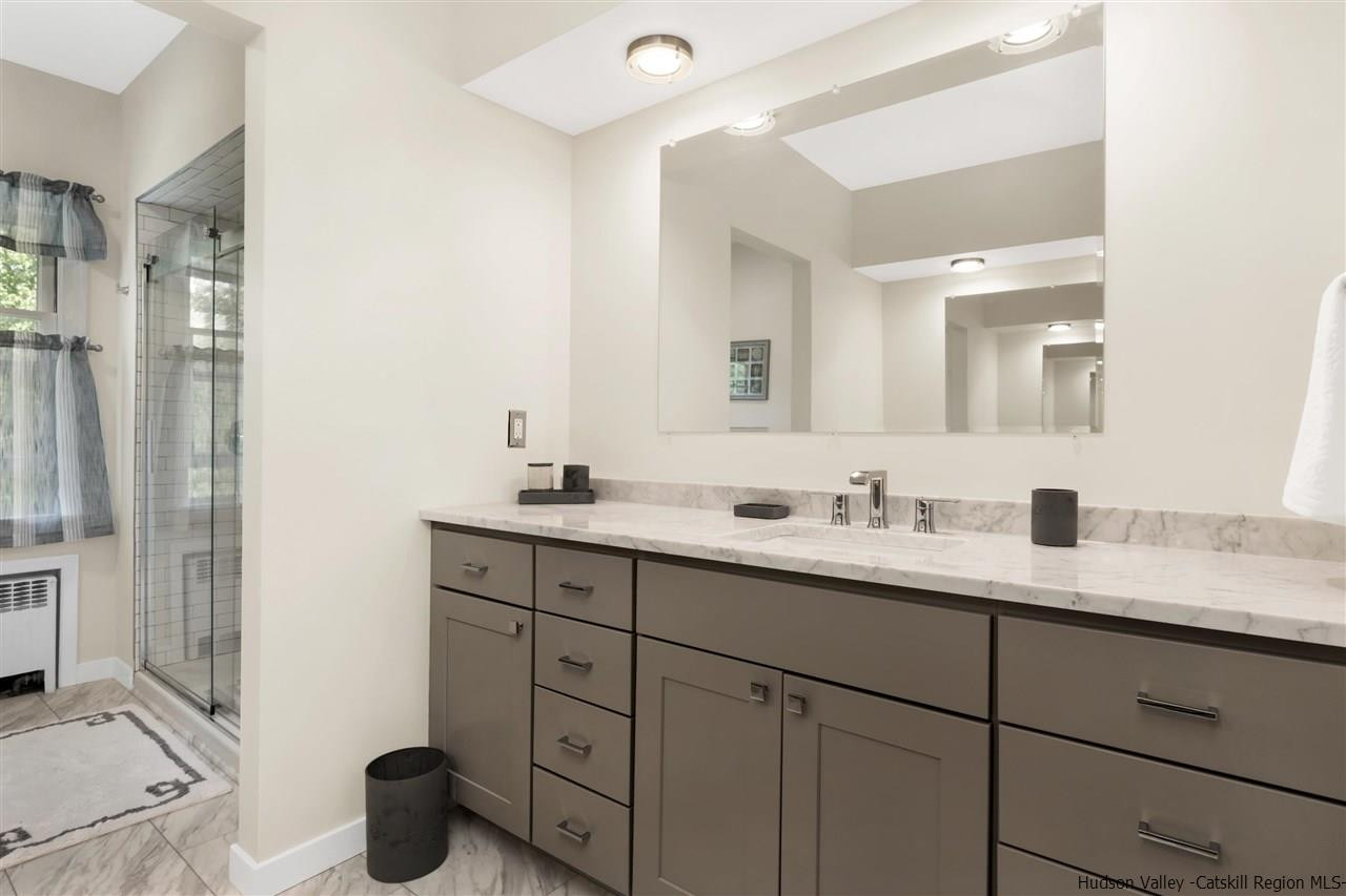 295 Game Farm Road Catskill, NY 12414 - Photo 23 of 35 a bathroom with a double vanity sink and a mirror