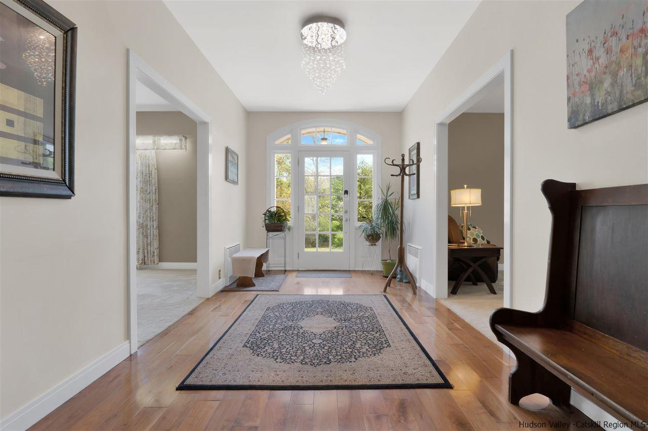 295 Game Farm Road Catskill, NY 12414 - Photo 4 of 35 a view of a hallway with wooden floor and a living room