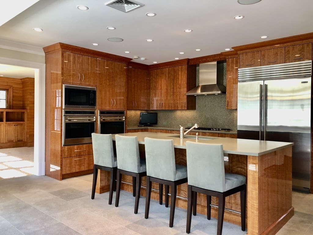 a large kitchen with a table and chairs