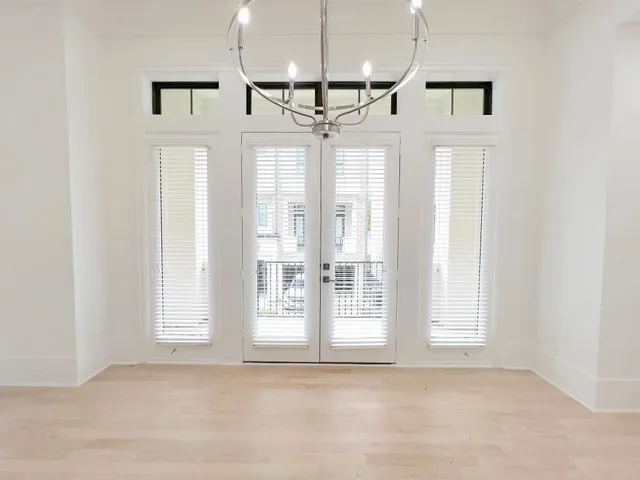 a view of entryway and kitchen with a ceiling fan