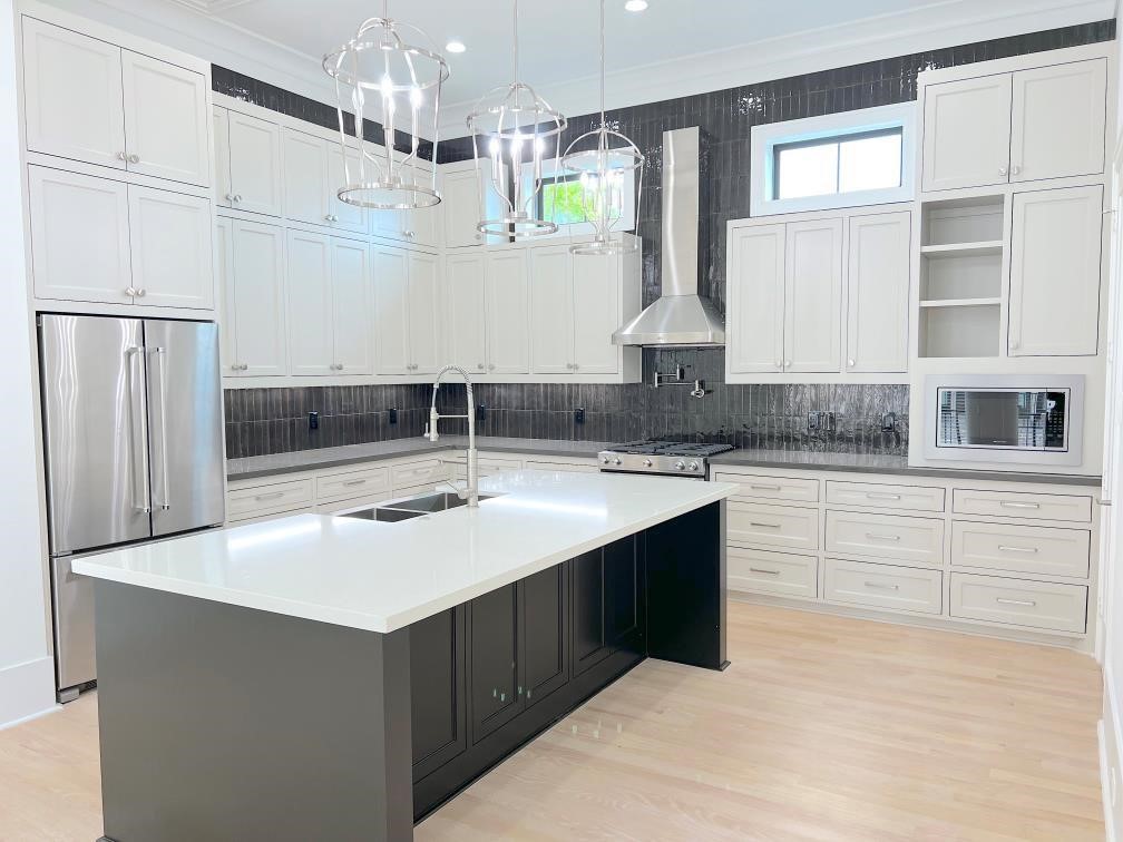 2122 Blalock Road, Unit B Houston, TX 77080 - Photo 16 of 45 a kitchen with stainless steel appliances granite countertop a sink and dishwasher a refrigerator with wooden floor