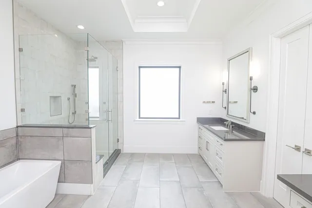 a bathroom with a granite countertop sink a toilet and bathtub