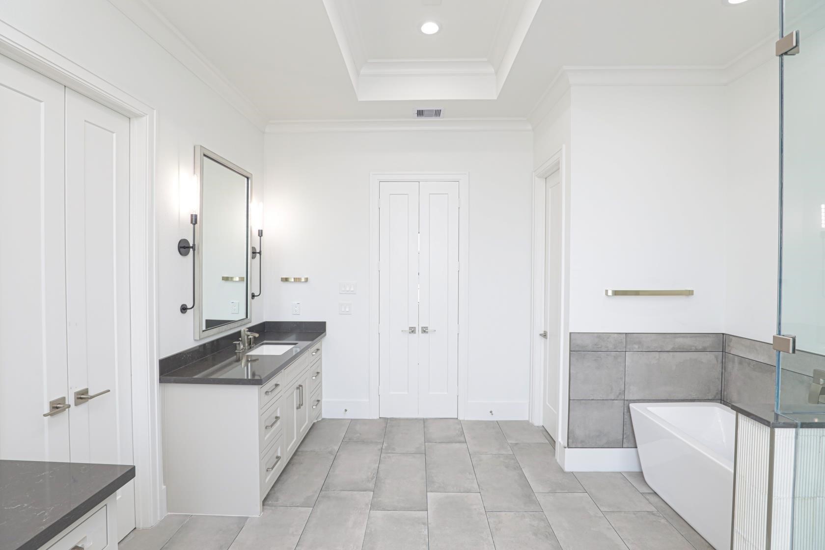2122 Blalock Road, Unit B Houston, TX 77080 - Photo 22 of 45 a spacious bathroom with a granite countertop sink and a mirror