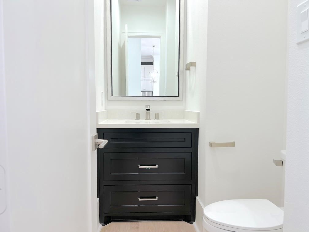 2122 Blalock Road, Unit B Houston, TX 77080 - Photo 35 of 45 a bathroom with a toilet sink and mirror
