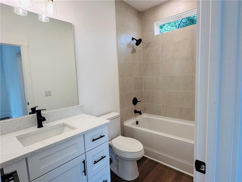 6312 Woodstock Road Acworth, GA 30102 - Photo 24 of 44 a bathroom with a sink a toilet and shower