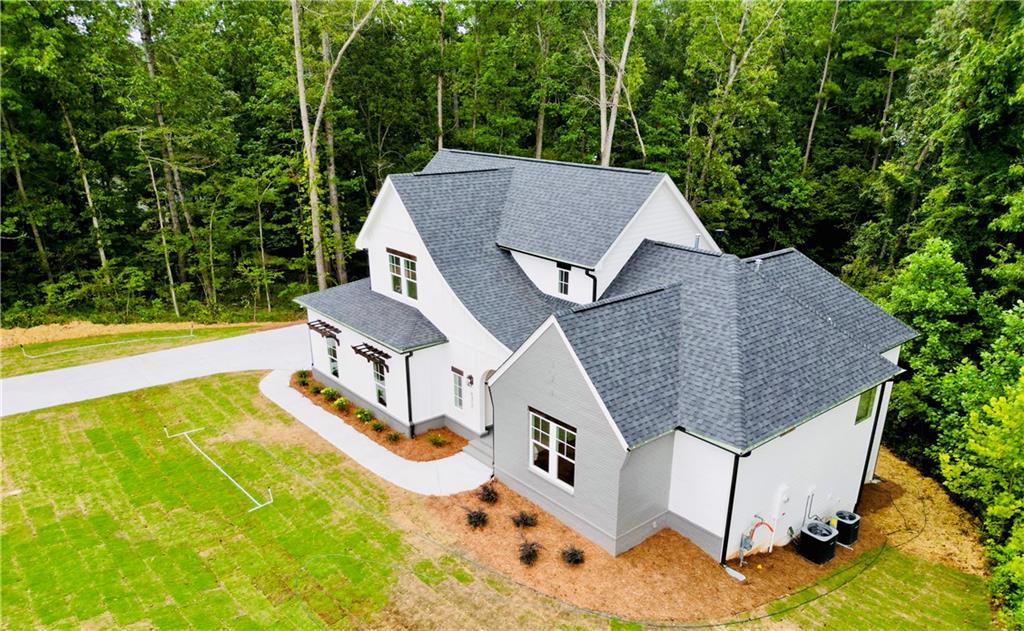 6312 Woodstock Road Acworth, GA 30102 - Photo 3 of 44 an aerial view of a house with swimming pool garden view and trees