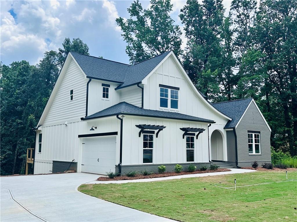 6312 Woodstock Road Acworth, GA 30102 - Photo 33 of 44 a front view of a house with a yard and garage