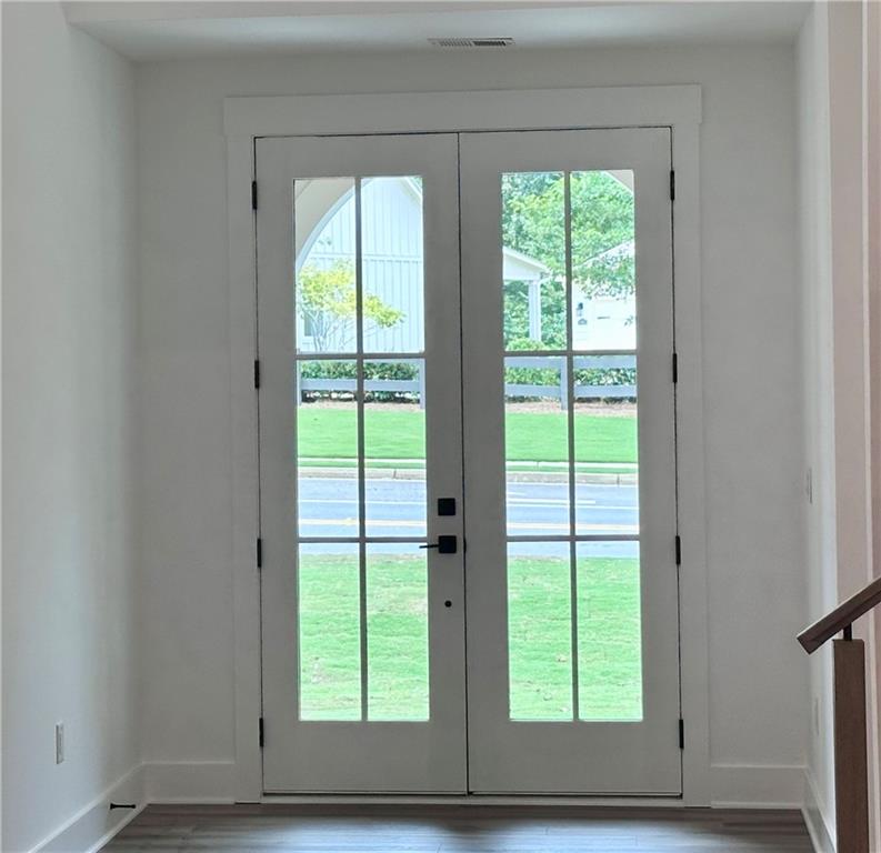 6312 Woodstock Road Acworth, GA 30102 - Photo 41 of 44 a view of an empty room with wooden floor and a window