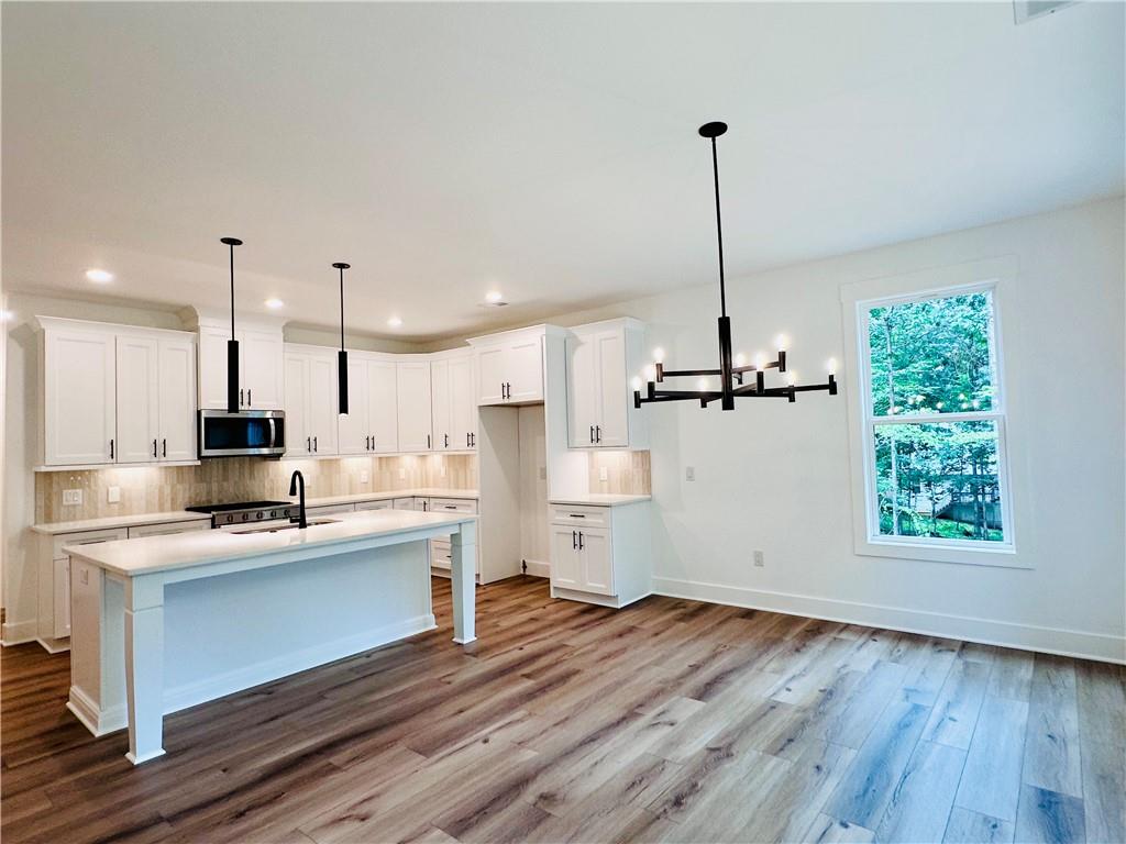 6312 Woodstock Road Acworth, GA 30102 - Photo 9 of 44 a view of a kitchen with kitchen island a counter space a sink appliances and cabinets