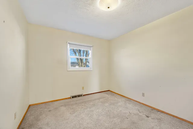 an empty room with a empty space and a window