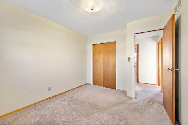 a view of an empty room and closet area