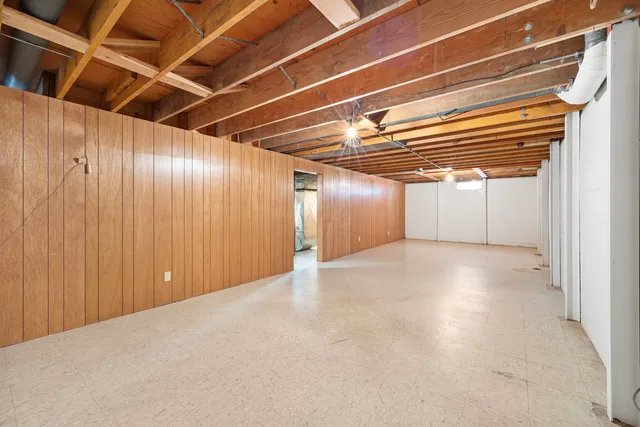 a room with table tennis table and a potted plant