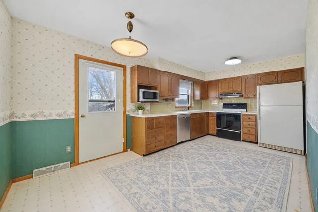 a kitchen with stainless steel appliances granite countertop a refrigerator sink and cabinets