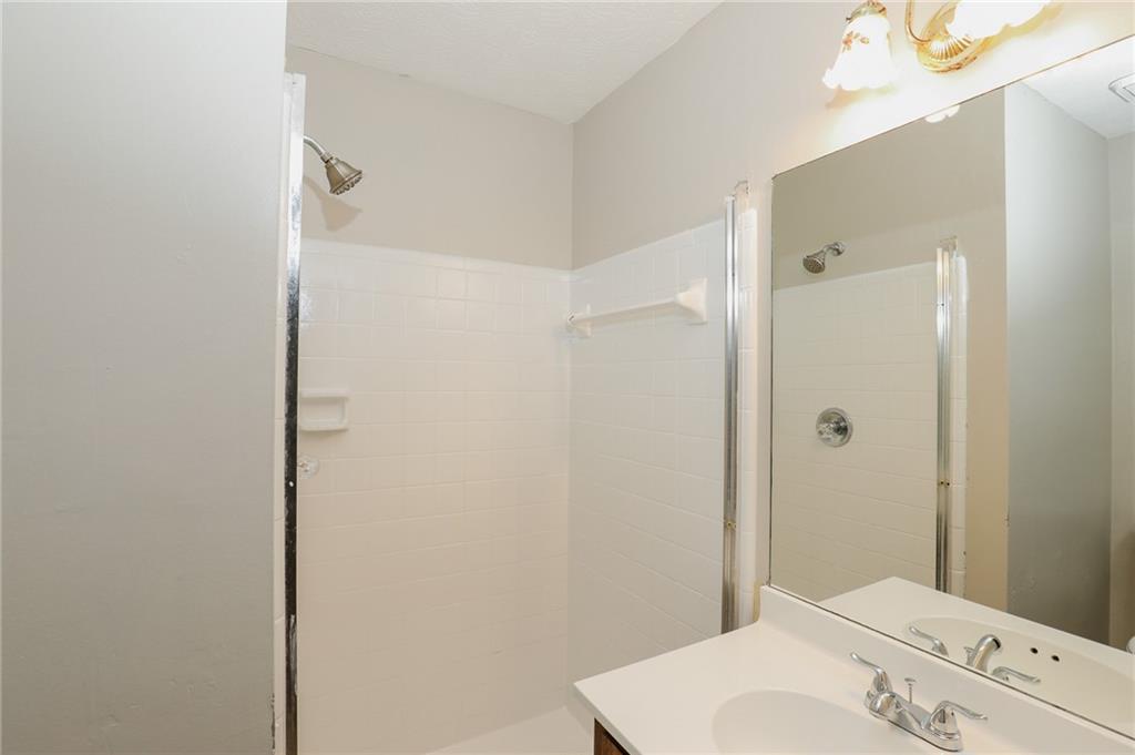 5299 Weyden Court, Unit A Norcross, GA 30071 - Photo 11 of 14 a bathroom with a sink a toilet and shower