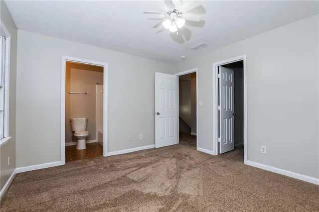 a view of an empty room and a bathroom