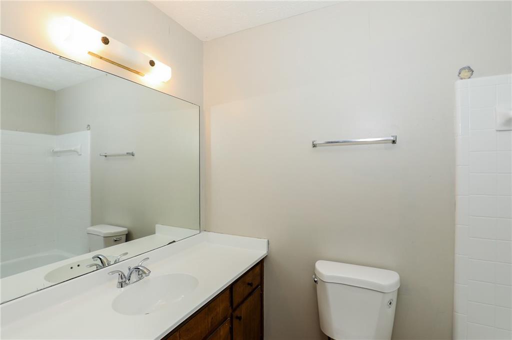 5299 Weyden Court, Unit A Norcross, GA 30071 - Photo 10 of 14 a bathroom with a sink a toilet and shower