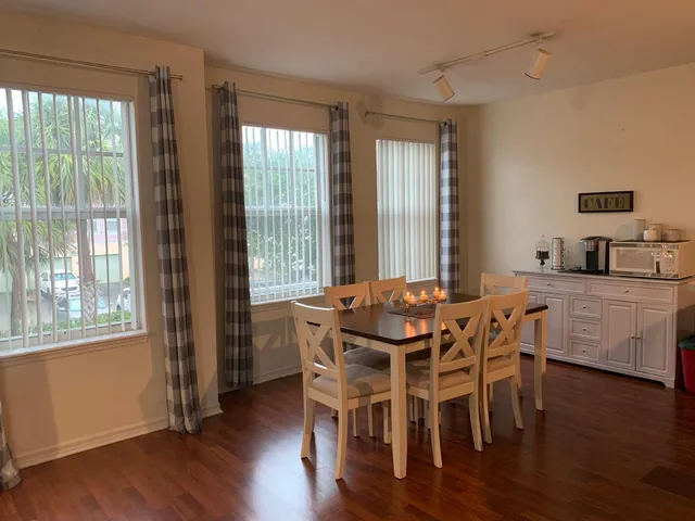 a view of a dining room with furniture and wooden floor