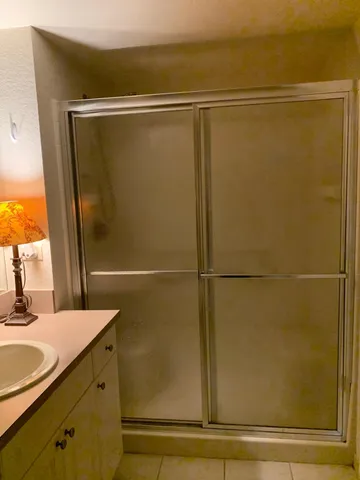 a bathroom with a shower and a sink