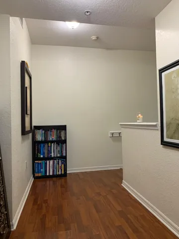 a view of a room with wooden floor and shelf