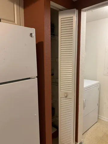 a white refrigerator freezer and a dishwasher