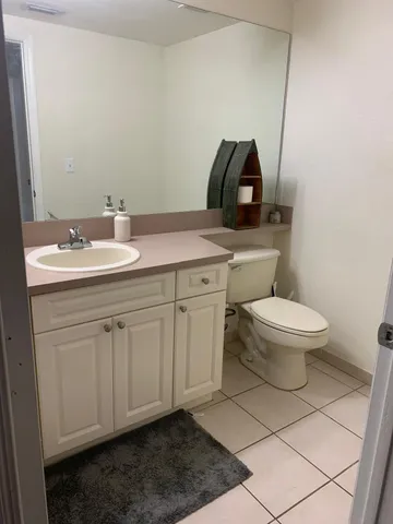 a kitchen with a stove a refrigerator and a sink