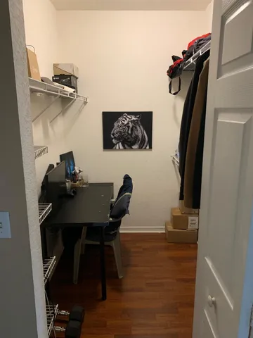 a view of a workspace with furniture and wooden floor