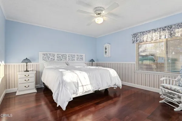 a bedroom with a large bed and a window