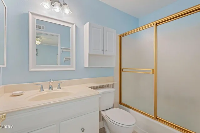 a bedroom with a bed and a ceiling fan