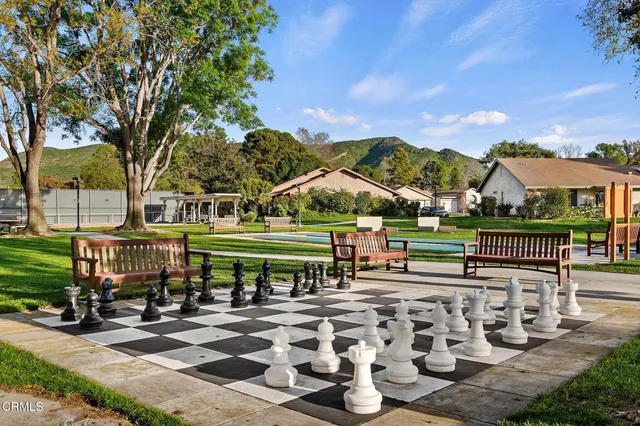 a living room with furniture a flat screen tv and kitchen view