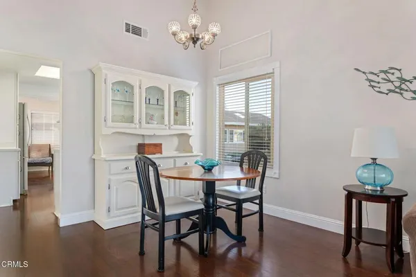 a kitchen with stainless steel appliances granite countertop a lot of counter space and wooden floors