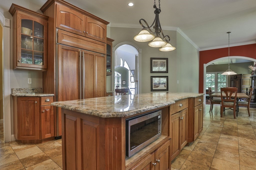 14 Collins Road Berlin, MA 01503 - Photo 3 of 42 a kitchen with stainless steel appliances granite countertop wooden cabinets a stove a sink and a dining table