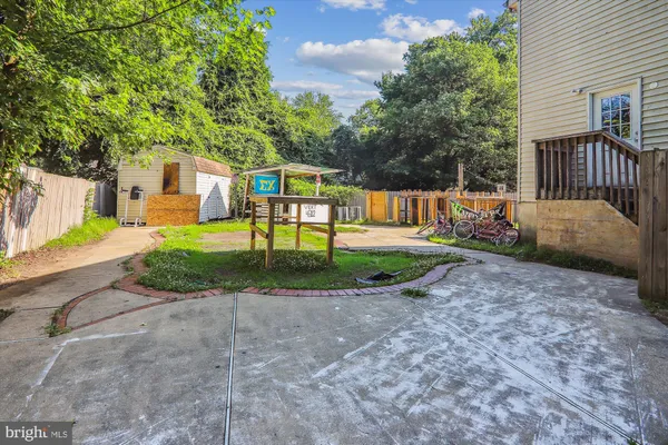 a view of a house with a yard and tree s