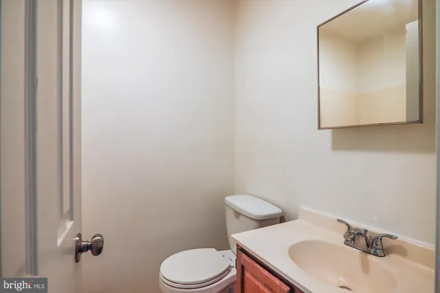 a bathroom with a sink a toilet and mirror