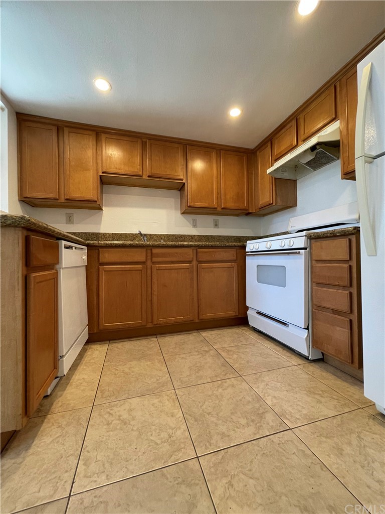 a kitchen with stainless steel appliances granite countertop a sink and cabinets