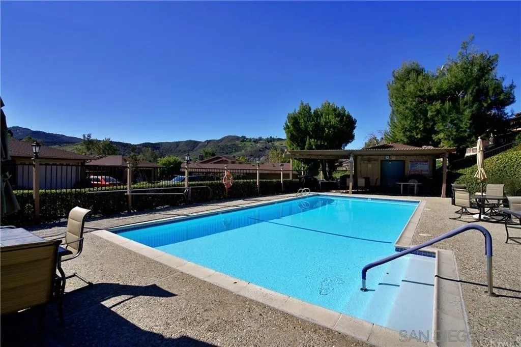 8525 Circle R Course Lane Escondido, CA 92026 - Photo 13 of 13 a view of a swimming pool with a couches chairs and wooden floor